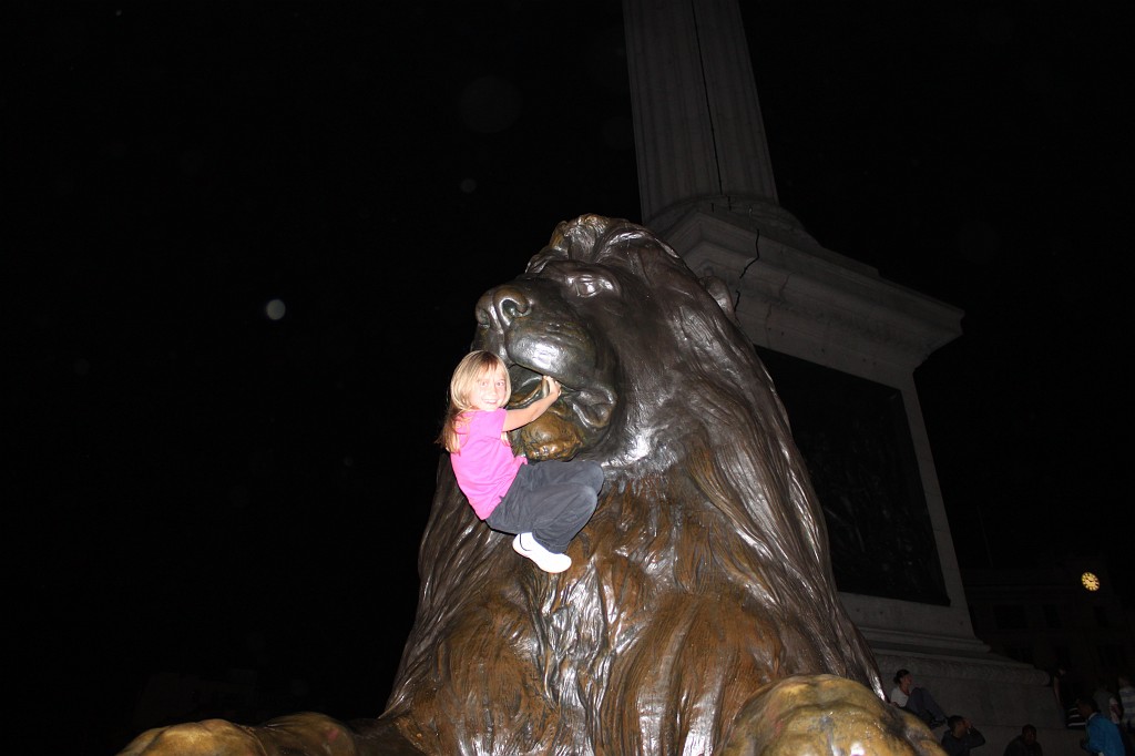IMG_2476.JPG - Naomi on Trafalgar Square Lion  http://en.wikipedia.org/wiki/Trafalgar_Square 