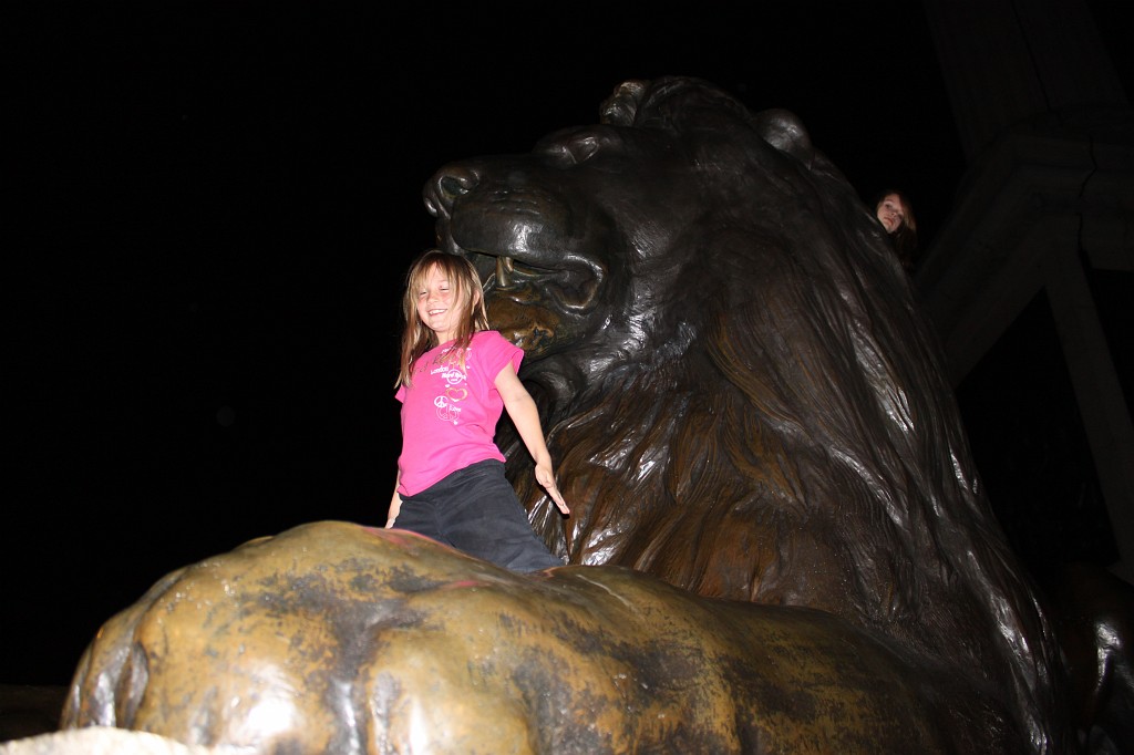 IMG_2477.JPG - Naomi on Trafalgar Square Lion  http://en.wikipedia.org/wiki/Trafalgar_Square 