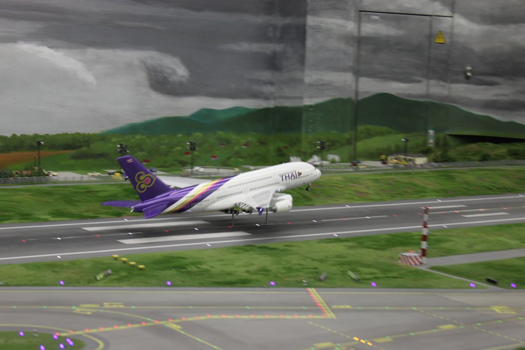 IMG_5881.JPG - Thai Airways A380 taking off in the  Miniatur Wunderland  ( miniature wonderland ). The world largest miniature railway not only host trains but also running cars, trucks, ship and even "flying" airplanes.
