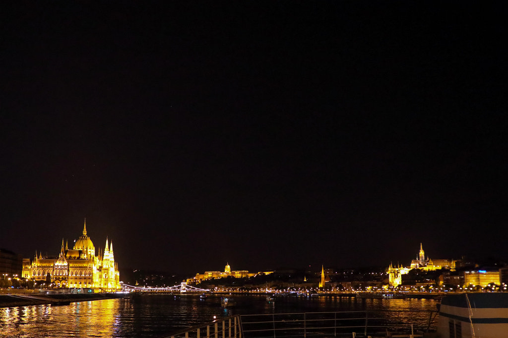 574B7070_c.jpg - Sail away from  Budapest . To the left is the  Hungarian Parliament Building , to the right is the  Matthias Church  with the  Fisherman's Bastion  and in the center above the  Danube  is  Buda Castle 
