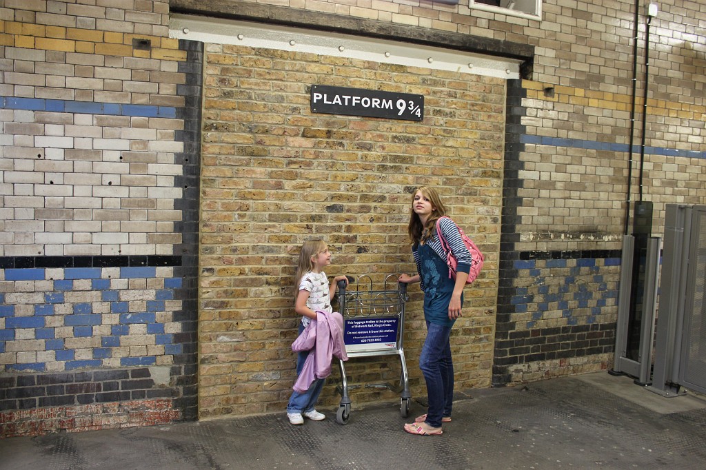 IMG_2053.JPG - Naomi and Sarina entering platform 9 3/4 at Kings Cross  http://en.wikipedia.org/wiki/Platform_9_3/4#Platform_Nine_and_Three_Quarters 