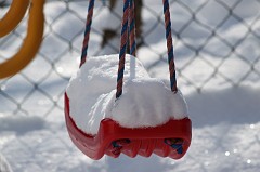 Snow covered swing